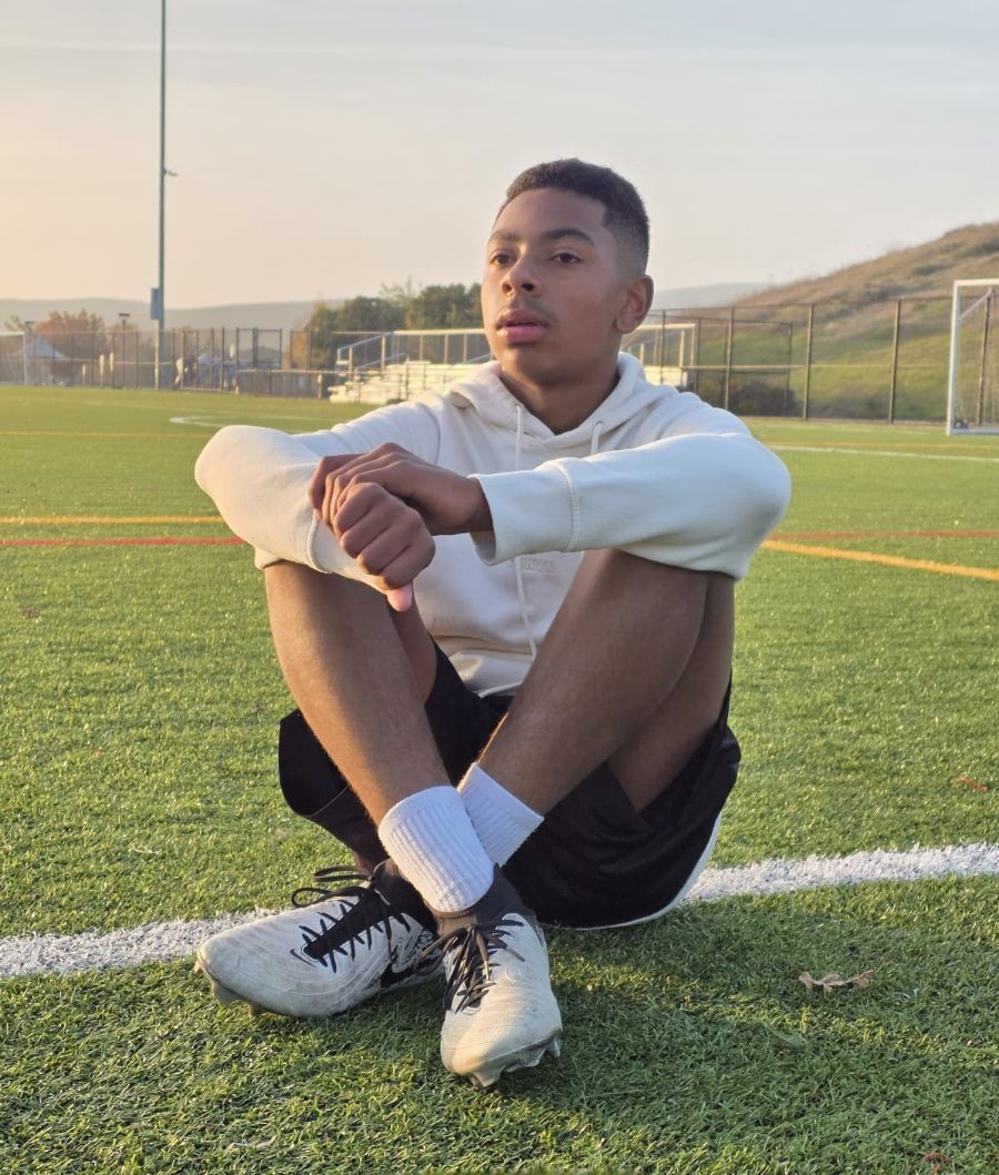 Fabi on the pitch at sunset, in boots and training kit
